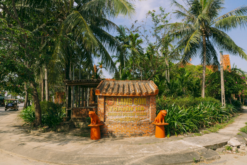 The entrance to Thanh Ha Pottery Village in Hoi An is made from traditional materials, standing out against the picturesque rural landscape